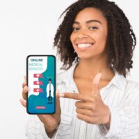 Girl holding phone with online medical services on screen