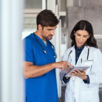 Doctor and nurse discussing report